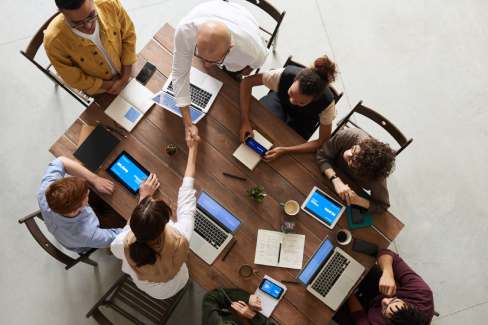 A B2B sales team analyzing data on a laptop, representing strategies used by top lead generation companies in Dubai.